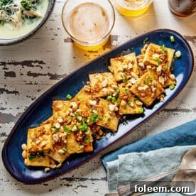 Spicy, Sweet and Nutty Tofu on a long blue platter.