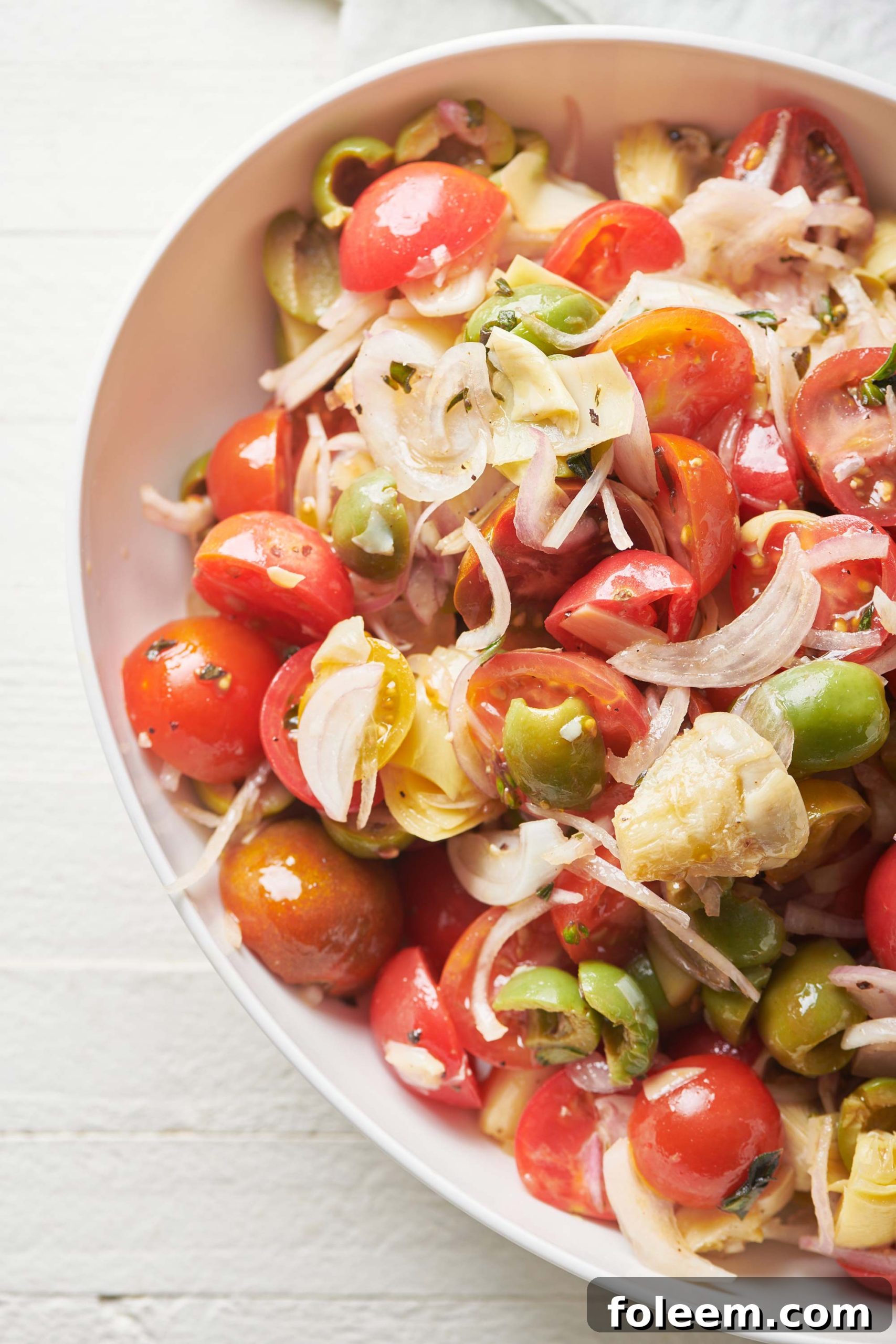 Roasted Cherry Tomatoes Recipe for Flavorful Side Dish 3 Cherry Tomato Antipasti Salad in white bowl.