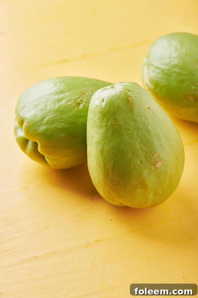 3 full whole chayote on wood.
