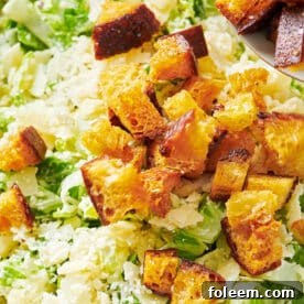 Homemade croutons on salad in bowl.