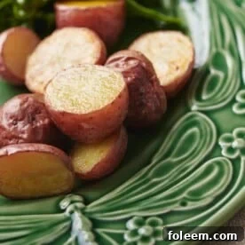 Roasted potatoes on green plate.