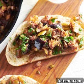 Caponata bruschetta on a wooden board.