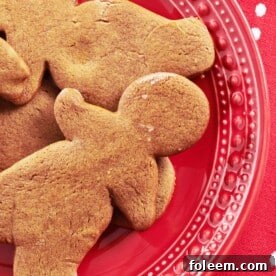Gingerbread men on a red plate.