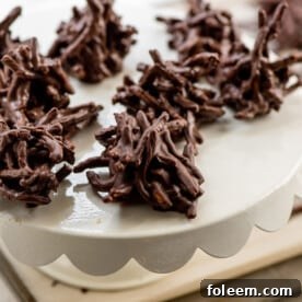 White serving dish of Chocolate, Peanut and Pretzel No-Bake Haystack Cookies.