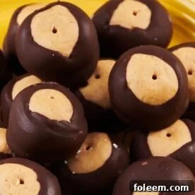 Chocolate covered buckeye balls on yellow plate