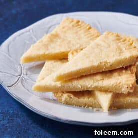 Shortbread Cookies stacked on white plate.