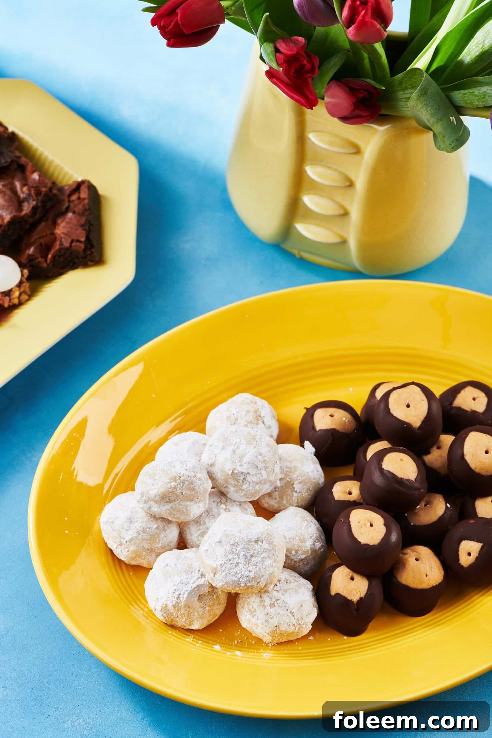 Nut-Free Snowball Cookies and Buckeyes on a yellow platter.