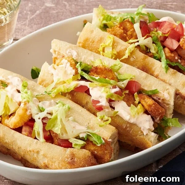 Three Shrimp Po Boy sandwiches in platter.