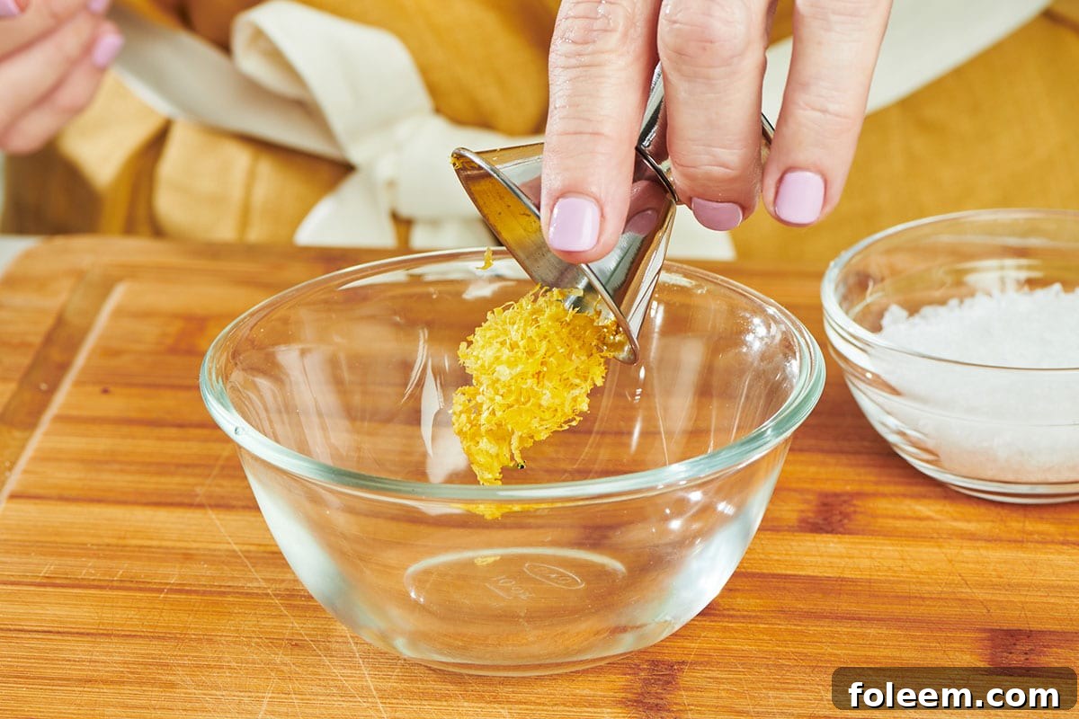 Pouring lemon zest into small glass bowl.