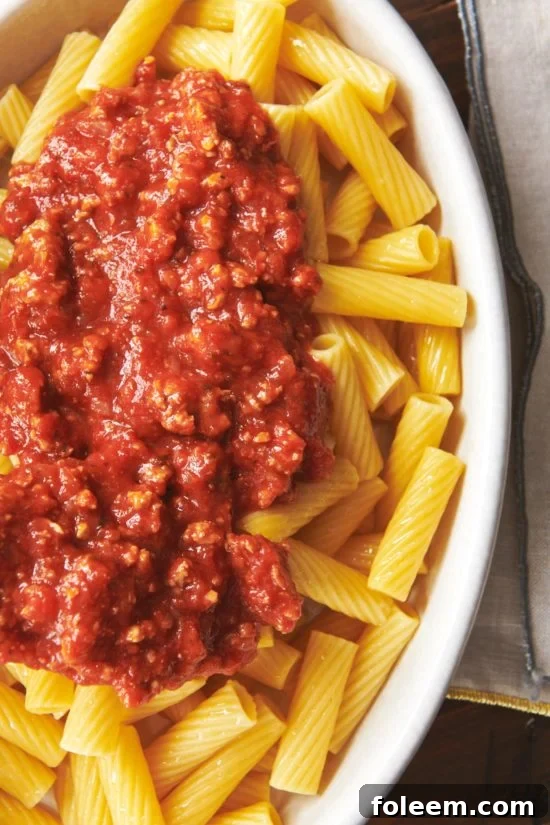 Turkey meat sauce over penne pasta on plate