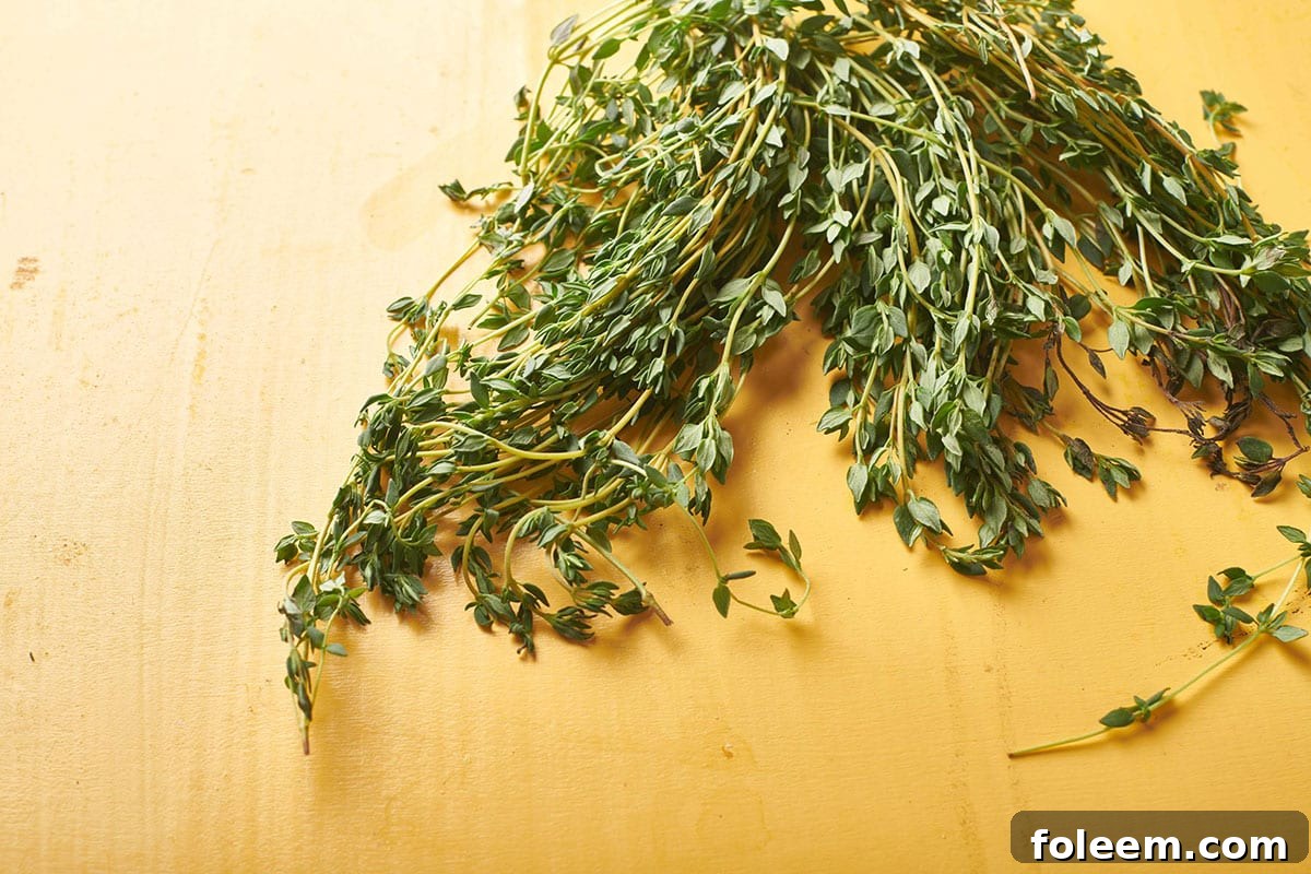 Sprigs of fresh thyme on cutting board.