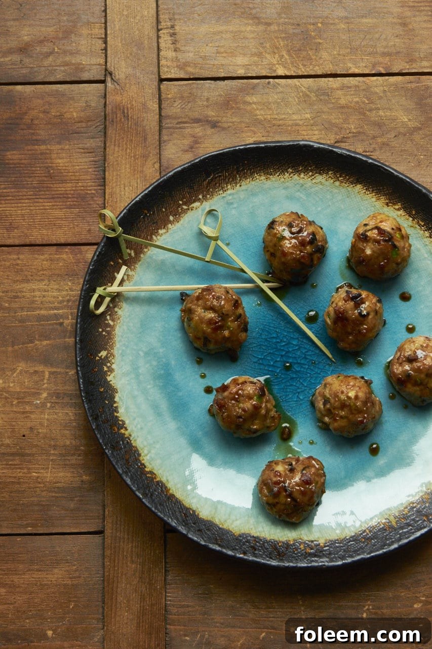 Japanese Meatballs with Ponzu Glaze on blue plate.