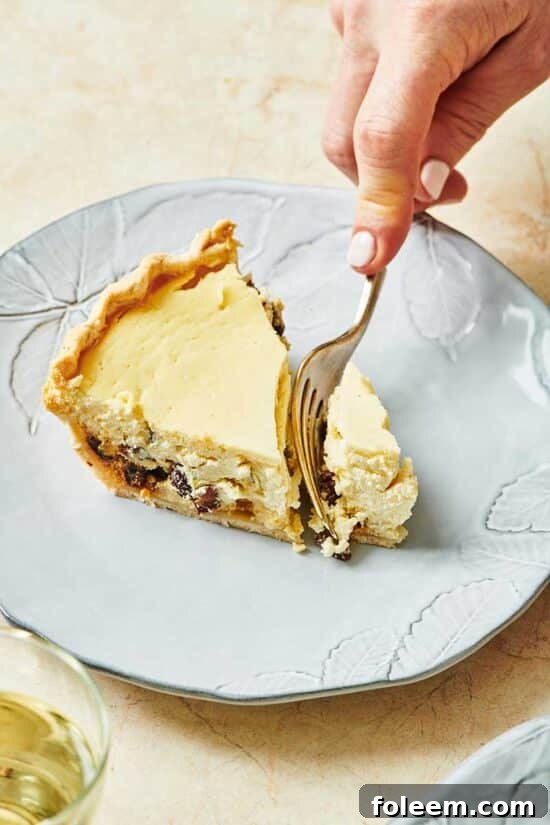Cutting a slice of ricotta pie with fork