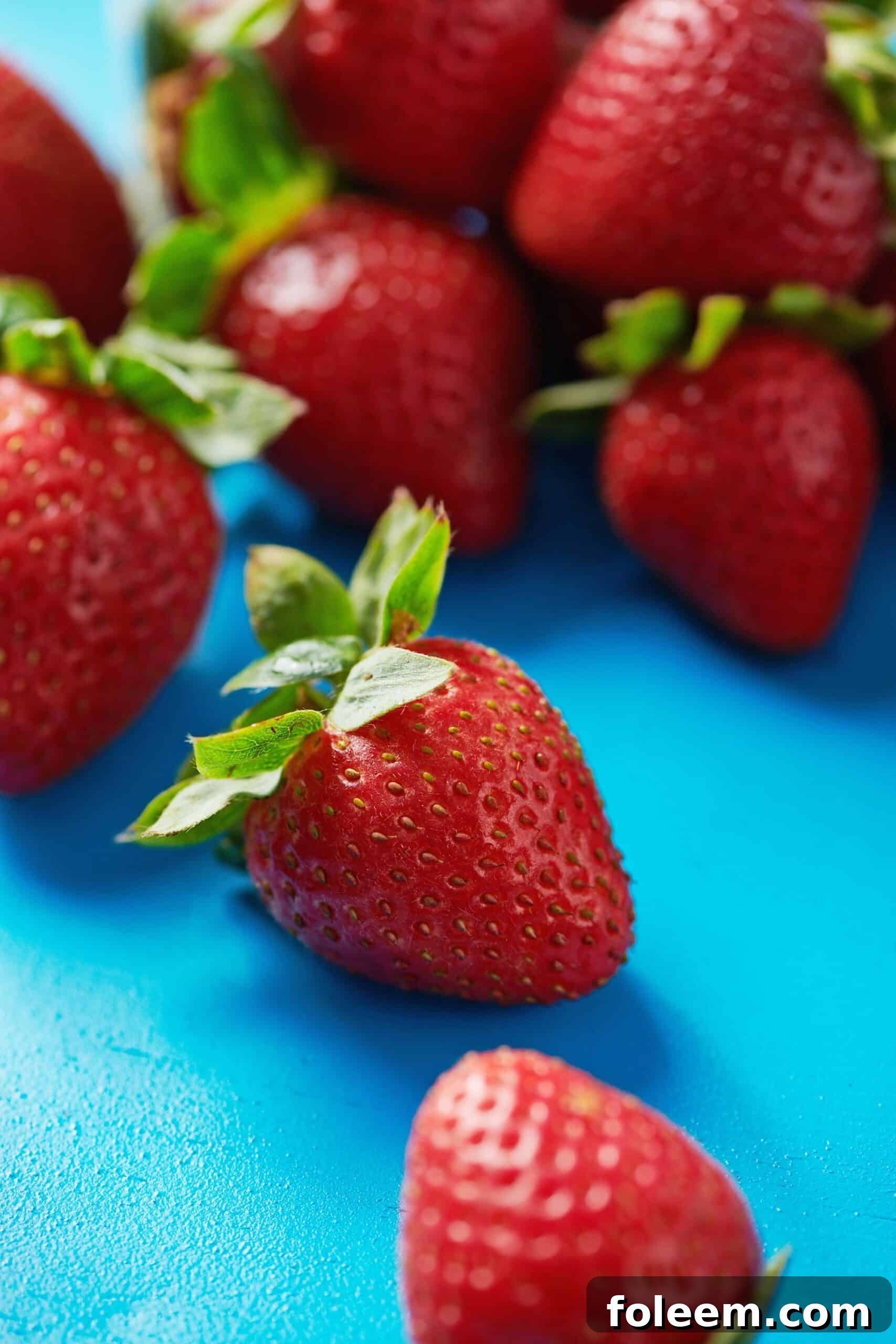Fresh strawberries on blue table.