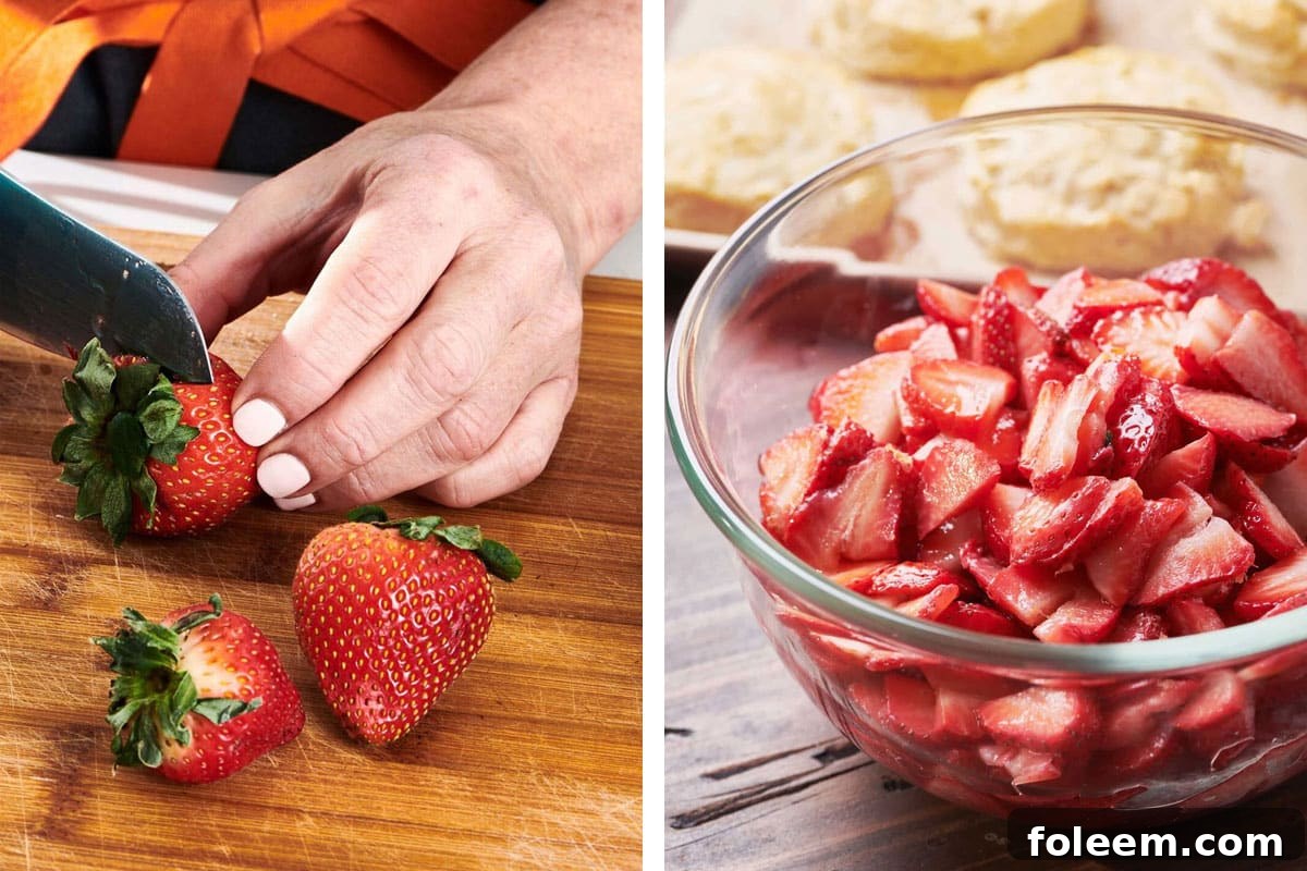 Slicing strawberries on cutting board and placing in glass bowl.