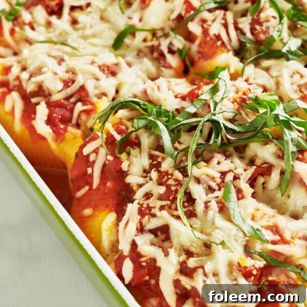 Stuffed Shells topped with mozzarella cheese and basil.