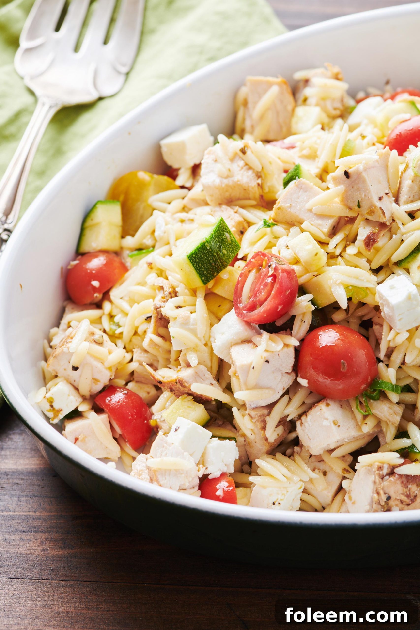 Greek Chicken Pasta Salad in serving bowl on table.