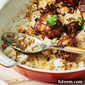 Spoon in a partially-served dish of Chicken Adobo.