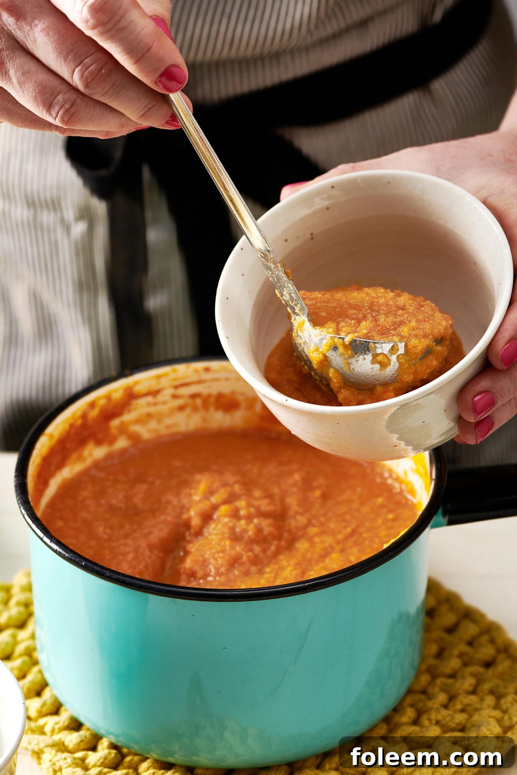 Scooping Moroccan Carrot and Cauliflower Soup in to bowl.