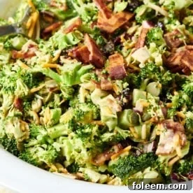 Bowl of Broccoli Salad topped with bacon and cheese.