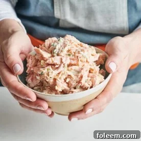 Woman holding a bowl of Salmon Spread.