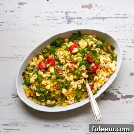 Bowl of Mayo-Free Vegan Pasta Salad on a white, wooden table.