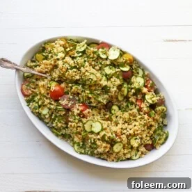 Tomato, Zucchini and Bulgur Salad in bowl with spoon.