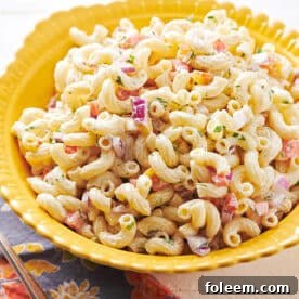 Old-fashioned macaroni salad in yellow bowl on table.