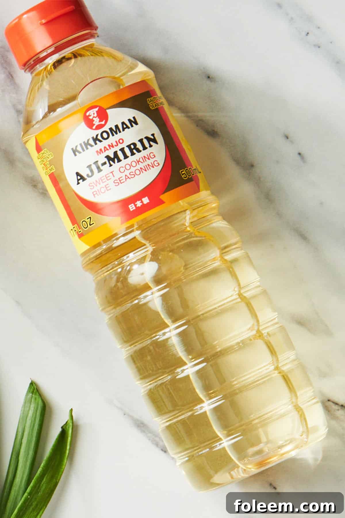 Bottle of aji-mirin on white marble table.