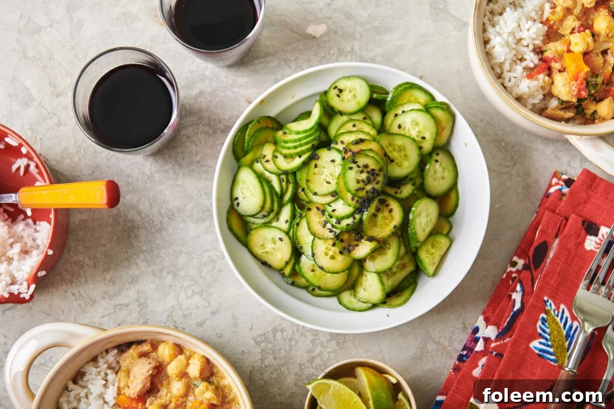 Bowl of Japanese Cucumber Salad on a table with other food.