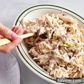 Scooping Chicken Salad out of bowl.