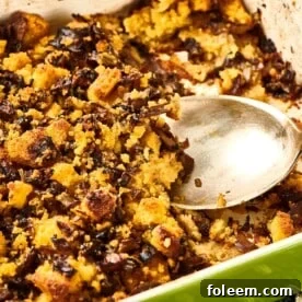 Spoon in a pan of Cornbread Dressing.