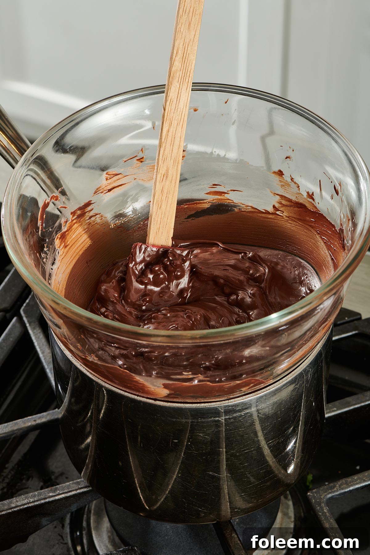 Chocolate melted in double boiler on stovetop.