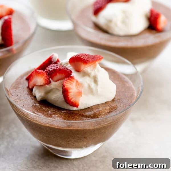 Chocolate mousse with strawberries and whipped cream.