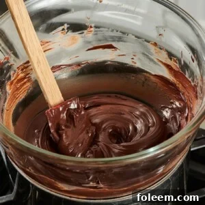 Chocolate melted in a homemade double boiler on the stove.