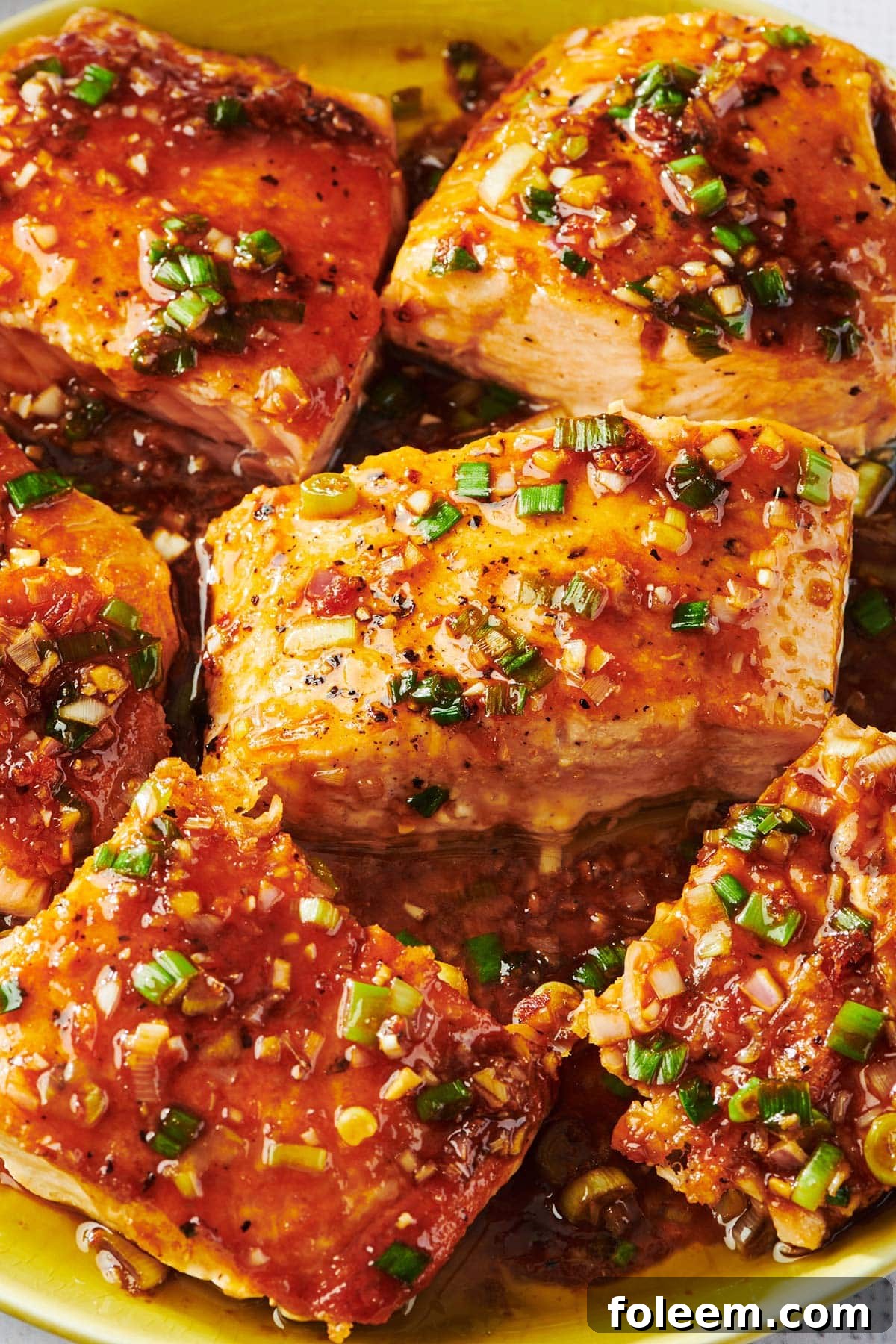 Ginger lemongrass salmon piled on plate.