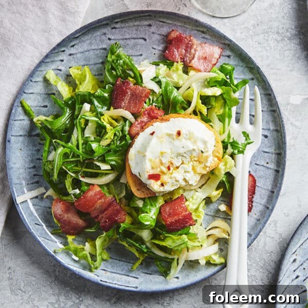 Bistro salad topped with baguetted and warm goat cheese on plate.
