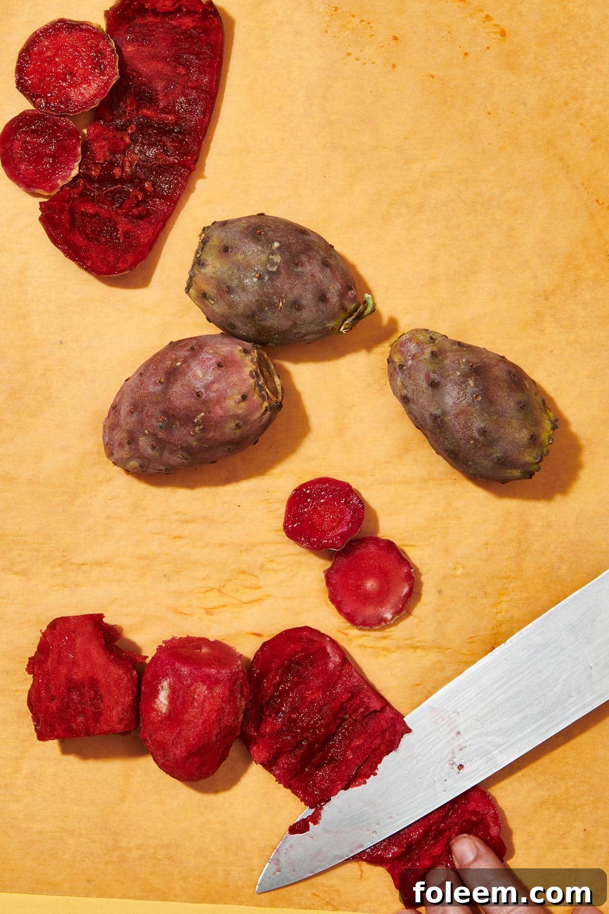 Preparing fresh prickly pears on cutting board.