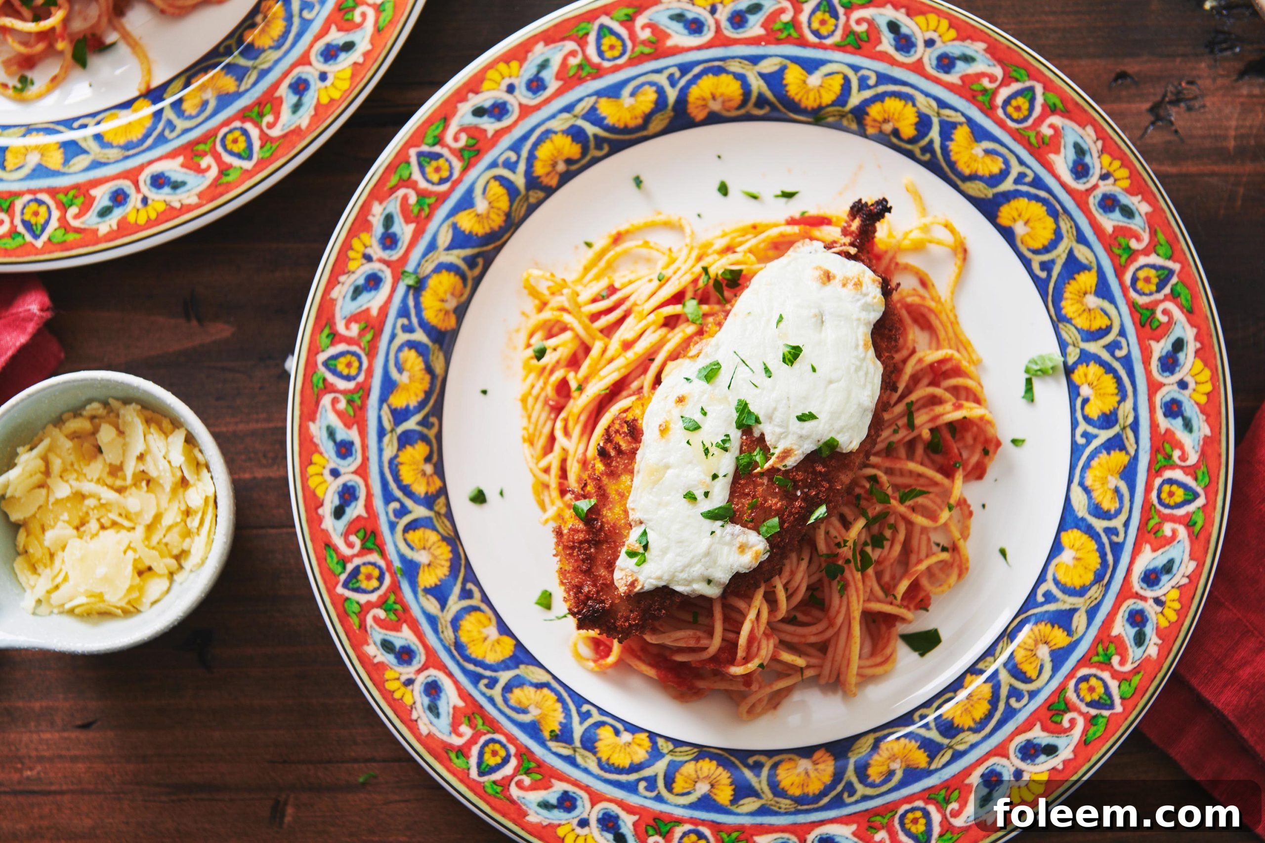 Chicken Parmigiana with spaghetti on a plate.