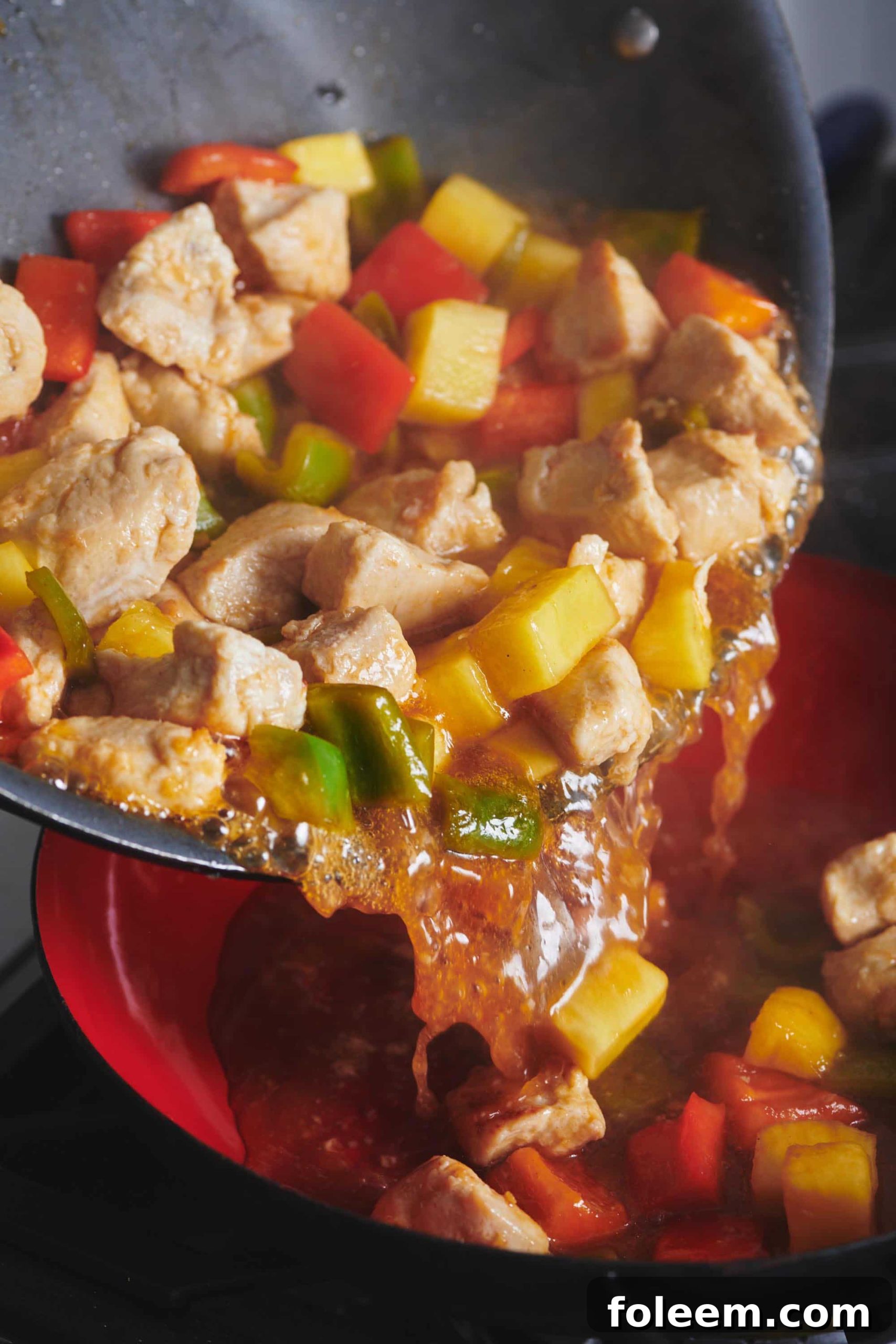 Sweet and Sour Chicken in red bowl.
