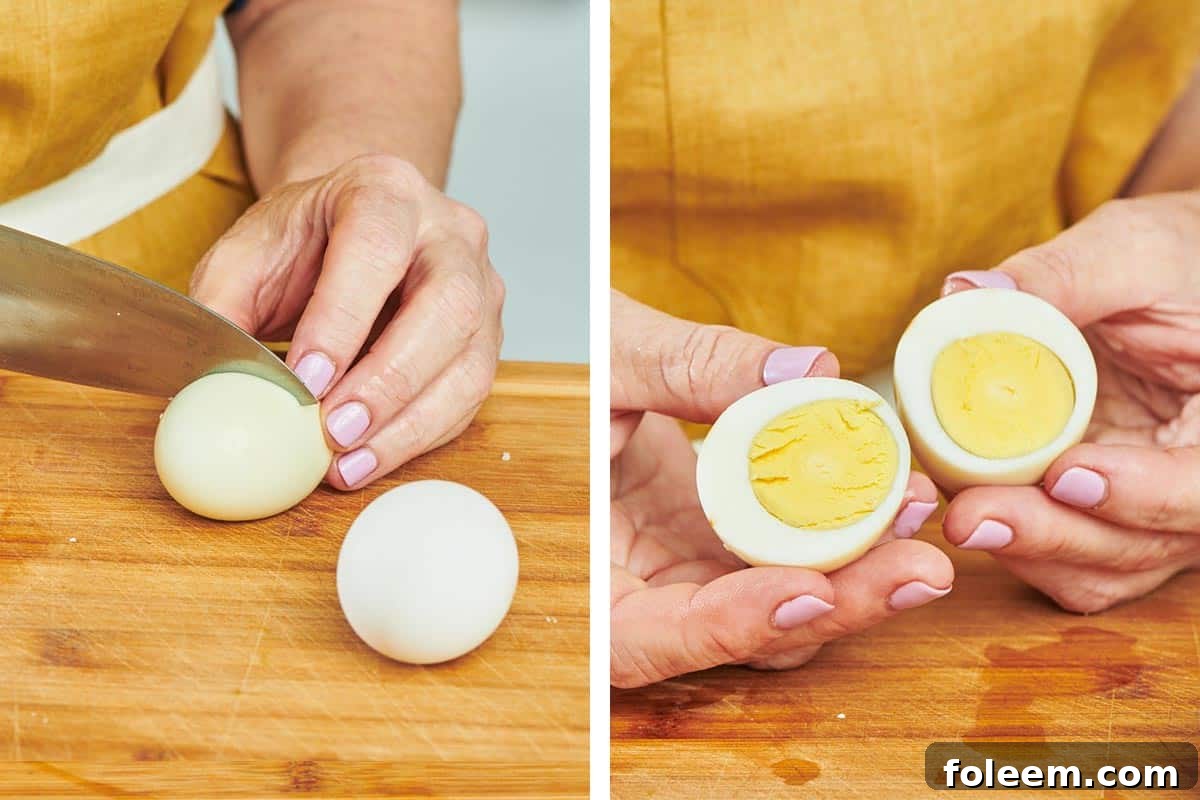 Woman cutting hard-cooked egg on wood board.
