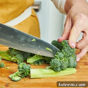 Cutting broccoli with knife.