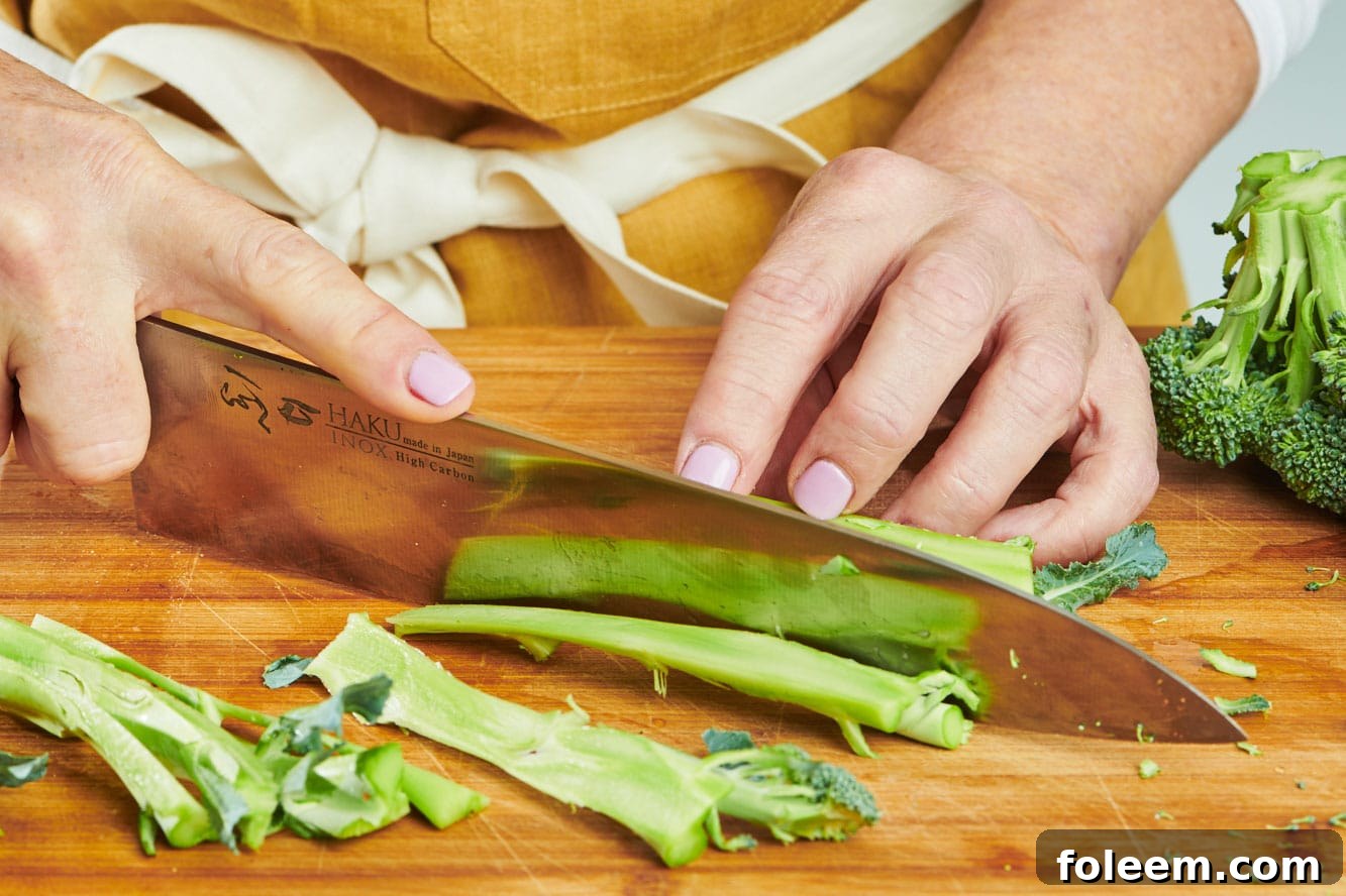 Trimming broccoli peel with knife.
