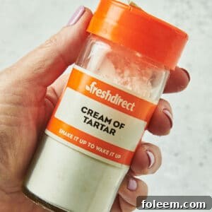 Woman holding cream of tartar bottle.
